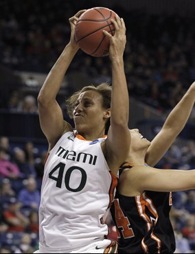 Miami's Shawnice Wilson (40) grabs a rebound in front of Idaho State's Cydney Horton in the first half of an NCAA tournament first-round women's...