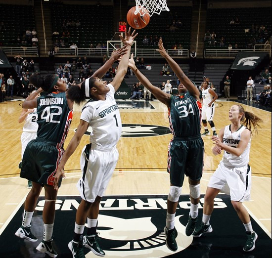 Miami's Shenise Johnson (42), Michigan State's Jasmine Thomas (1), Miami's Sylvia Bullock (34) and Michigan State's Taylor Alton, right, reach for a...