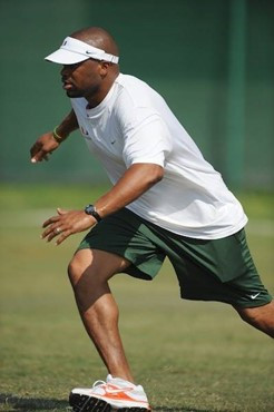 University of Miami Hurricanes linebackers coach Michael Barrow teaches his players technique in drills at Greentree Practice Field on August 13 to...
