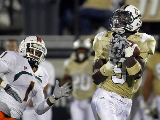 Central Florida wide receiver Jamar Newsome, right, catches a first down pass just out of the reach of Miami defensive back Brandon Harris (1) during...