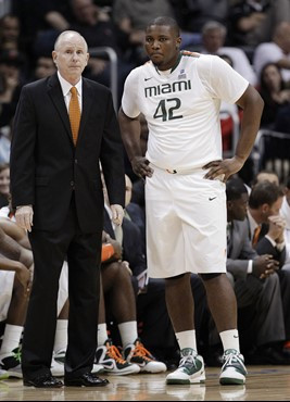 Miami coach Jim Larranaga stands with center Reggie Johnson during the first half. (AP Photo/Chuck Burton)