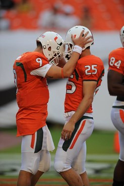 University of Miami Hurricanes kicker/punter Matt Bosher #25 and quarterback Robert Marve #9  in a game against the University of Central Florida...