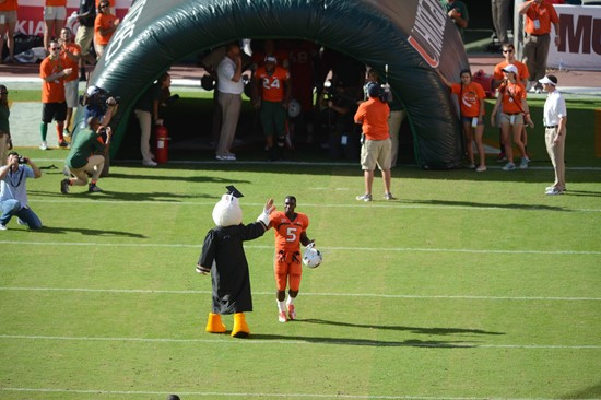 Sebastian the Ibis leads the University of Miami Hurricanes through a tunnel of smoke in a game against the University of South Florida Bulls at Sun...
