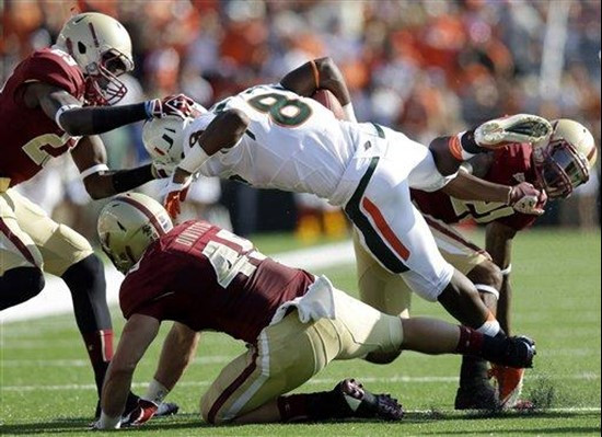 Miami running back Duke Johnson (8) carries the ball against Boston College defensive back Jim Noel (23), linebacker Steele Divitto (49), and...