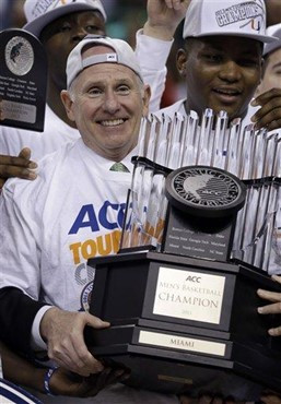 Miami head coach Jim Larranaga holds the trophy after an NCAA college basketball game against North Carolina in the championship of the Atlantic Coast...