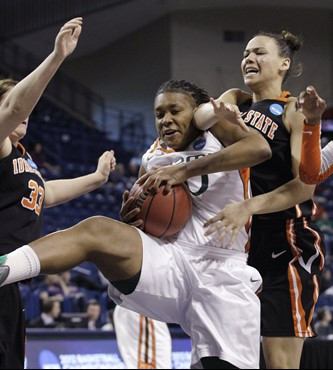 Miami's Maria Brown, center, brings down a rebound between Idaho State's Cydney Horton, right, and Taylor Floyd in the second half of an NCAA...