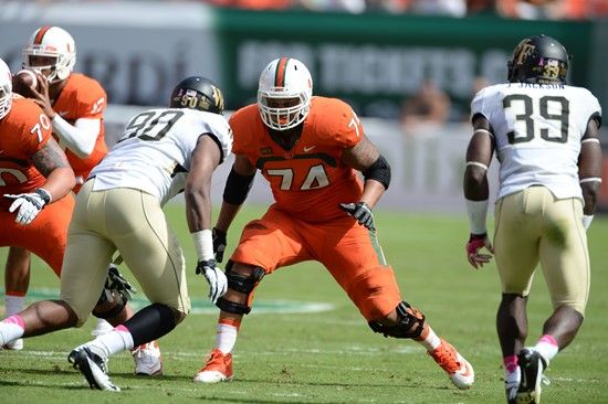 University of Miami Hurricanes offensive lineman Ereck Flowers #74 gets set to block against the Wake Forest Demon Deacons at Sun Life Stadium on...