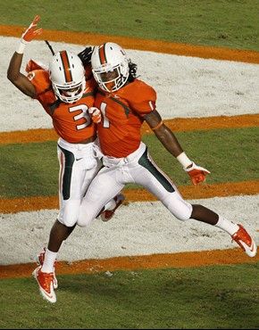 Miami wide receiver Travis Benjamin, left, and wide receiver Allen Hurns celebrate Hurns'  touchdown during the first quarter of an NCAA college...