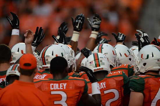 University of Miami Hurricane players join hands in a sign of unity before a game against the Arkansas State Red Wolves at Sun Life Stadium on...
