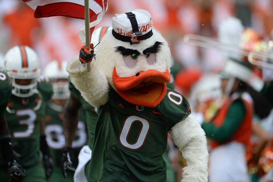Sebastian the Ibis leads the University of Miami Hurricanes through a tunnel of smoke in a game against the Arkansas State Red Wolves at Sun Life...