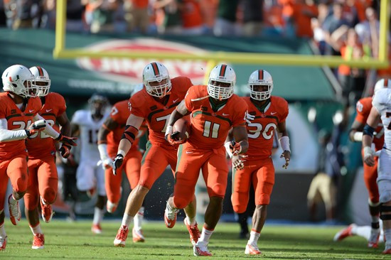 Defensive lineman David Gilbert #11 and The University of Miami Hurricanes plays in a game against the Virginia Cavaliers at Sun Life Stadium on...