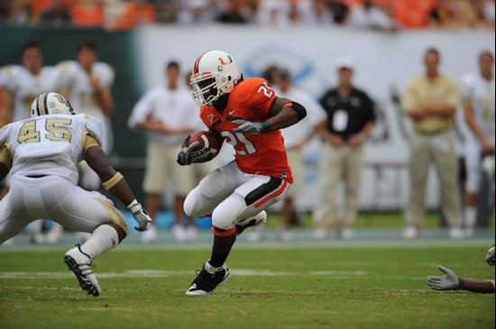 University of Miami Hurricanes running back Derron Thomas #21 carries the ball against the University of Central Florida Knights at Dolphin Stadium on...