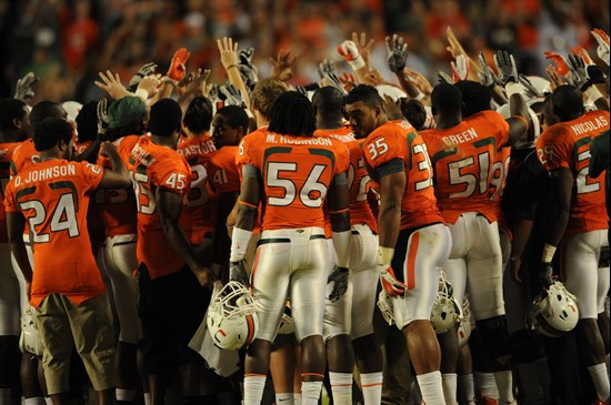 University of Miami Hurricane players meet in a sign of unity at the beginning of the fourth quarter against the Boston College Eagles at Sun Life...