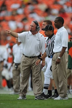 University of Miami Hurricanes head coach Randy Shannon discusses a play with assistant coaches on the sidelines in a game against the Virginia...