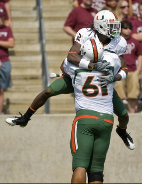 Graig Cooper jumps into the arms of after running for a 51-yard touchdown during the first quarter.