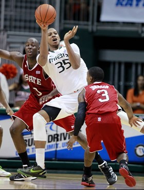 Miami's Kenny Kadji (35) passes out of the pressure by North Carolina State's DeShawn Painter (0) and State's Alex Johnson (3) during the second half....