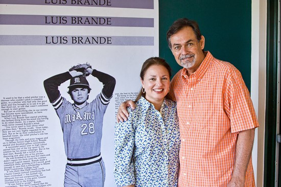 Luis and his wife Dora pose in front of the poster signed by all luncheon attendees.
