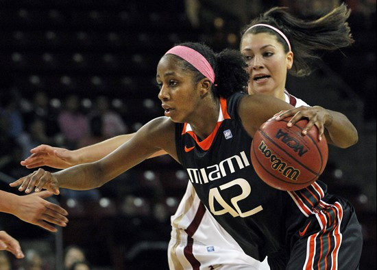 Miami's Shenise Johnson (42) drives against Boston College's Katie Zenevitch during the first half of an NCAA basketball game in Boston, Thursday,...