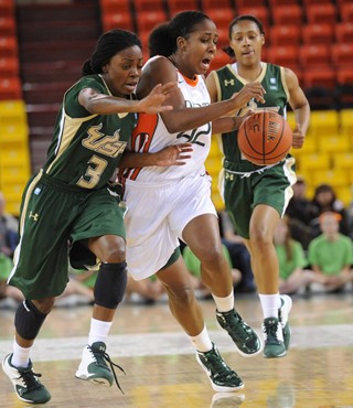 Miami's Shenise Johnson (42) drives upcourt against the defense of South Florida's Kaneisha Saunders. (AP Photo/Michael Dinneen)