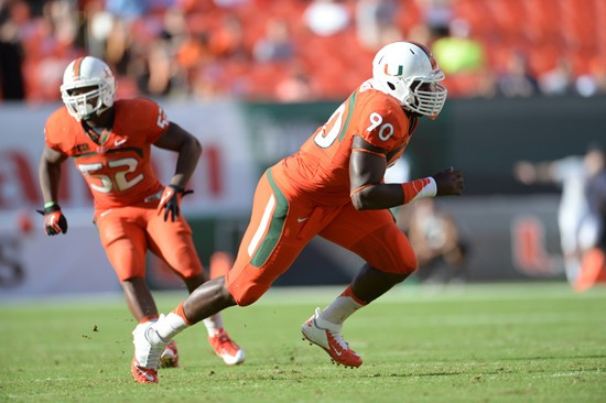 University of Miami Hurricanes defensive lineman Ufomba Kamalu #90 plays in a game against the Virginia Cavaliers at Sun Life Stadium on November 23,...
