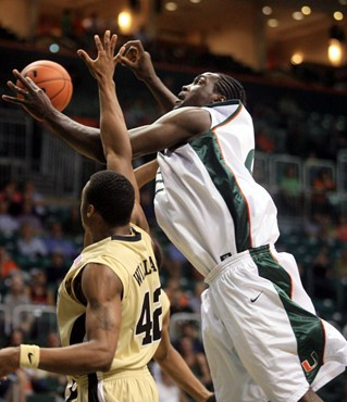 Miami's Dwayne Collins, right, tries to pull in a rebound over Wake Forest's L.D. Williams (42) during the first half of a basketball game Saturday,...