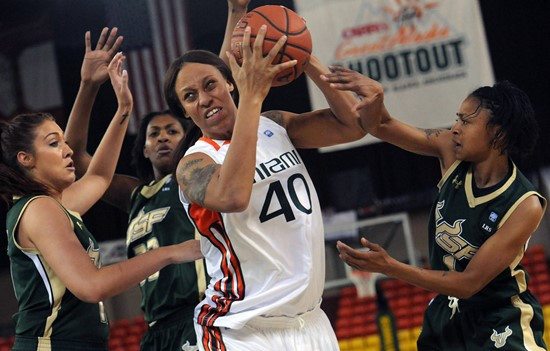 Miami's Shawnice Wilson (40) grabs a rebound with South Florida defenders Caitlin Rowe, left, Akila McDonald, rear, and Jasmine Wynn (1) during the...