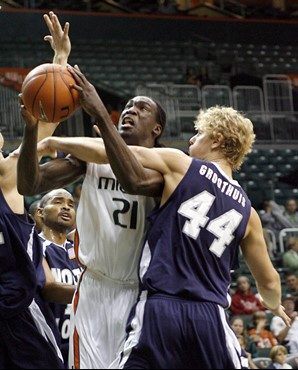 Dwayne Collins (21) is fouled by North Florida forward Kyle Groothuis (44) in the first half of a basketball game in Miami, Thursday, Dec. 20, 2007....