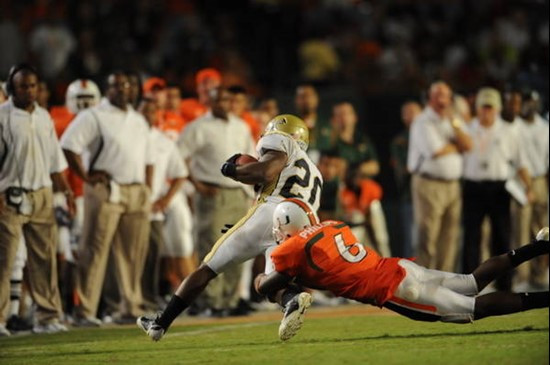 University of Miami Hurricanes defensive back Randy Phillips #6 makes the open field tackle in a game against the Georgia Tech Yellow Jackets at Land...