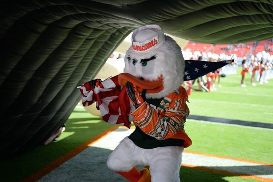 Sebastian the Ibis leads the University of Miami Hurricanes through a tunnel of smoke in a game against the North Carolina Tar Heels at Sun Life...
