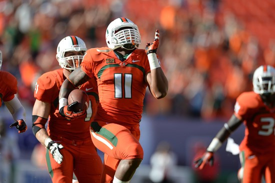Defensive lineman David Gilbert #11 and The University of Miami Hurricanes plays in a game against the Virginia Cavaliers at Sun Life Stadium on...