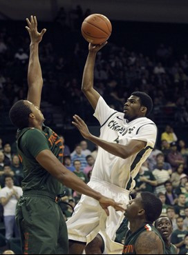 Charlotte's E. Victor Nickerson, top right, shoots over Miami's Kenny Kadji, left, during the first half of an NCAA college basketball game in...