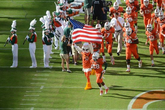 Sebastian the Ibis leads the University of Miami Hurricanes through a tunnel of smoke in a game against the University of South Florida Bulls at Sun...