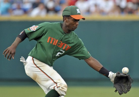 Miami second baseman Jemile Weeks can't control a ball hit by Stanford's Toby Gerhart during the second inning of an NCAA College World Series...