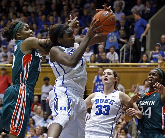 Duke's Elizabeth Williams (1) and Miami's Michelle Woods, left, struggle for a rebound during the first half. (AP Photo/Gerry Broome)