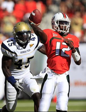 Miami quarterback Jacory Harris (12) passes as he is pressed by Georgia Tech linebacker Jeremiah Attaochu. (AP Photo/Wilfredo Lee)