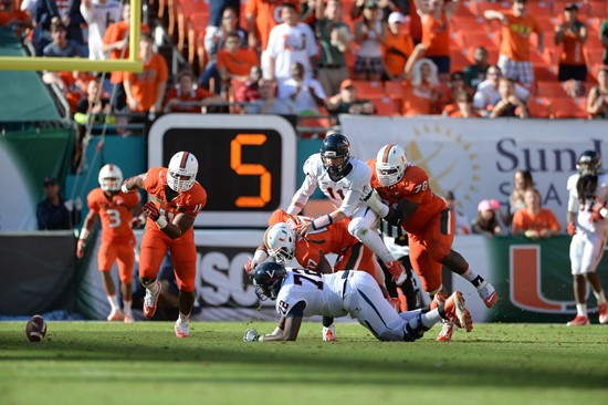 Defensive lineman David Gilbert #11 and The University of Miami Hurricanes plays in a game against the Virginia Cavaliers at Sun Life Stadium on...