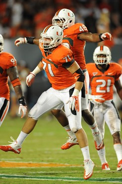 University of Miami Hurricanes defensive lineman Anthony Chickillo #71 celebrates with teammates after making a tackle in a game against the Ohio...