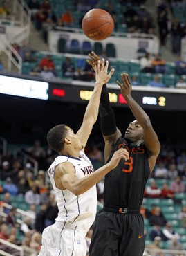 Miami's Malcolm Grant (3) shoots over Virginia's Mustapha Farrakhan (2) in the second half of Miami's 69-62 overtime win in an NCAA college basketball...