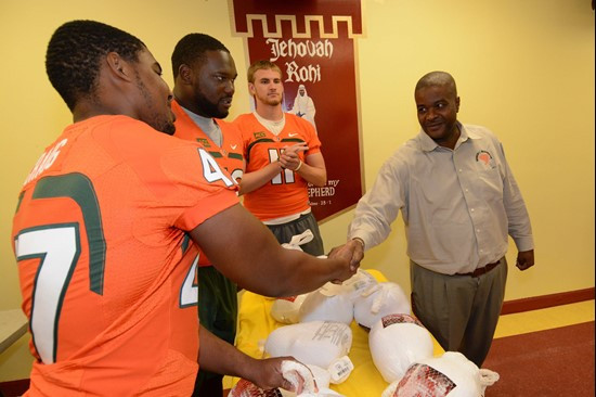 Akil Craig, Justin Renfrow and Ryan Williams handed out turkeys Tuesday afternoon