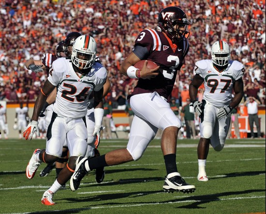 Virginia Tech quarterback Logan Thomas (3) scores a touchdown in front of Miami's Davon Johnson (24) and Adewale Ojomo (97) during the first half of...