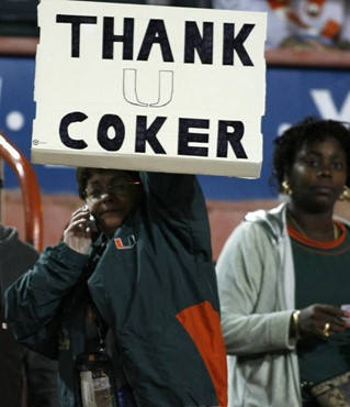 A Miami Hurricanes fan holds-up a sign showing support for Miami head coach Larry Coker before a college football game against Boston College,...