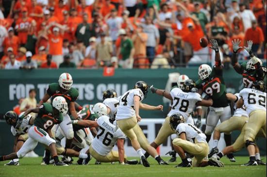 Wake Forest place kicker Shane Popham #14 misses a field goal attempt when the ball sails wide right.  Photo by Steven Murphy