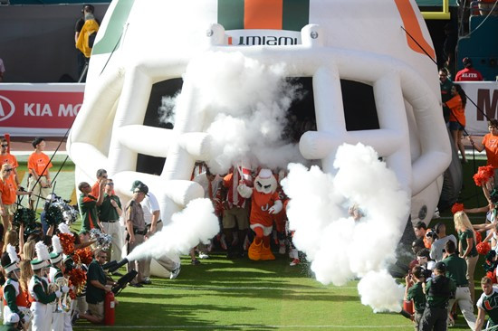 Sebastian the Ibis leads the University of Miami Hurricanes through a tunnel of smoke in a game against the University of South Florida Bulls at Sun...