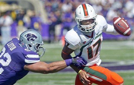 Miami quarterback Stephen Morris (17) is forced out of bounds by Kansas State defensive tackle Vai Lutui (92) during the first half of an NCAA...