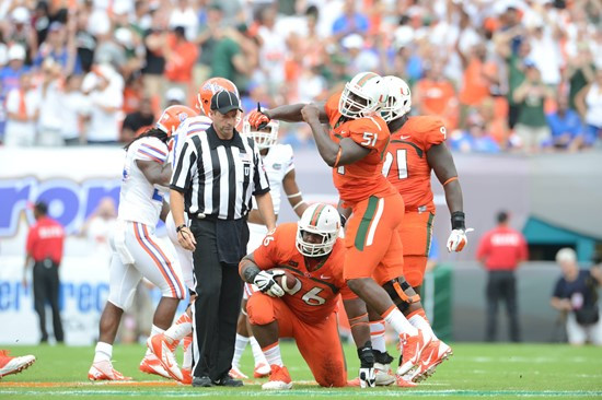 University of Miami Hurricanes defensive lineman Curtis Porter #96 plays in a game against the #12 ranked University of Florida Gators at Sun Life...