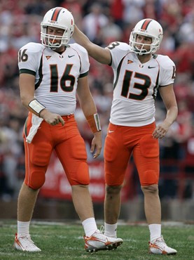 Miami place-kicker Jon Peattie, right, gives holder Matt Perrelli, left, a pat on the helmet as they react to a missed field goal-attempt during the...