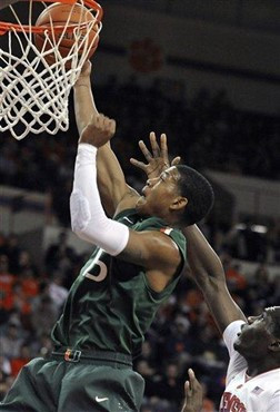 Miami's Rion Brown (15) shoots as Clemson's Landry Nnoko defends in the first half of an NCAA college basketball game, Sunday, Feb. 17, 2013, in...