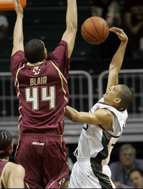 Boston College's Tyrelle Blair (44) blocks a shot by Miami's Denis Clemente, right, in the first half of a college basketball game in Coral Gables,...