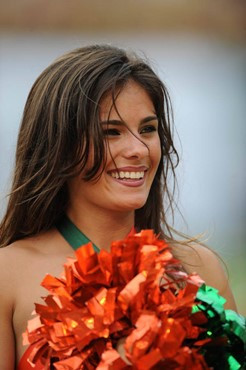 A University of Miami Hurricanes cheerleader pumps up the crowd in a game against the University of Central Florida Knights at Dolphin Stadium on...