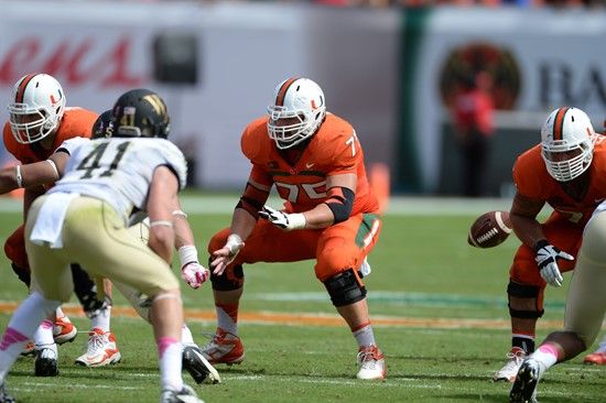 University of Miami Hurricanes offensive lineman Jared Wheeler #75 gets set to block against the Wake Forest Demon Deacons at Sun Life Stadium on...